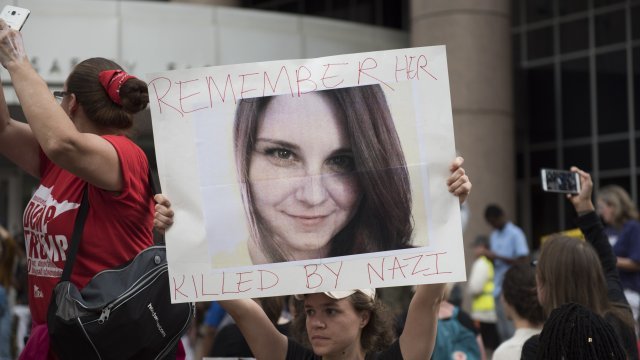 Protester holds sign commemorating woman killed at 'Unite the Right' rally in Charlottesville, VA