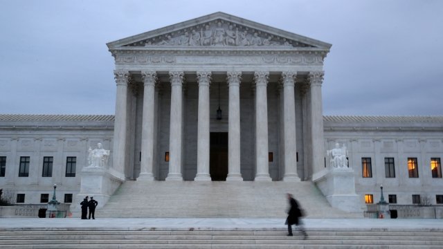 A man walks up the steps of the U.S. Supreme Court.