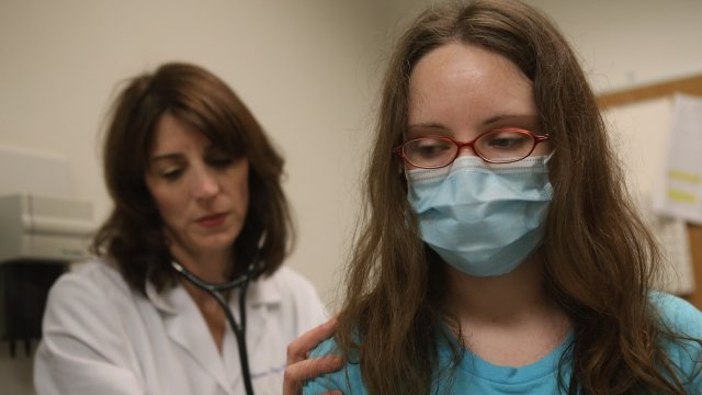 Doctor examines a patient with flu-like symptoms
