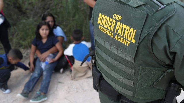 U.S. Border Patrol agent with asylum seekers