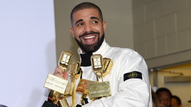 Drake poses with music awards
