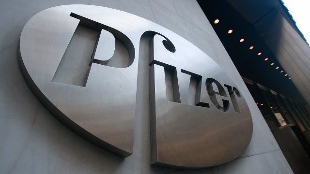 A Pfizer sign hangs on the outside of their headquarters.