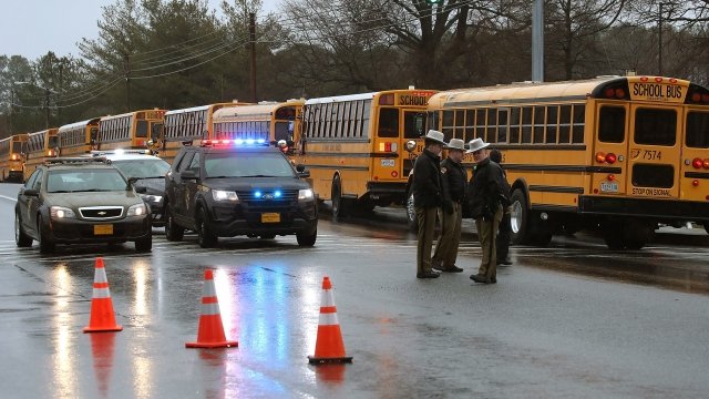 School buses are lined up in front of Great Mills High School after a shooting on March 20, 2018 in Great Mills, Maryland.