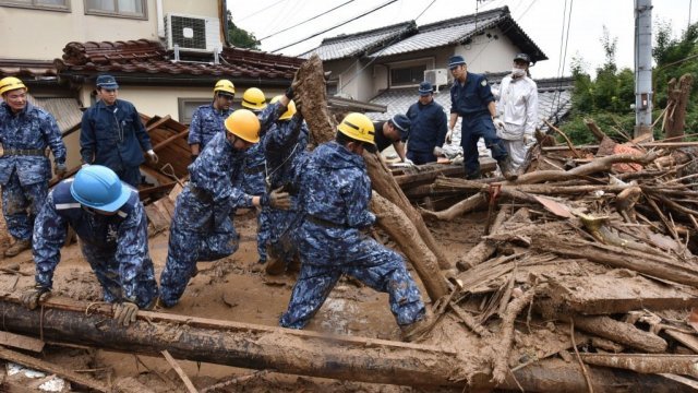 Workers search for missing people after heavy rains