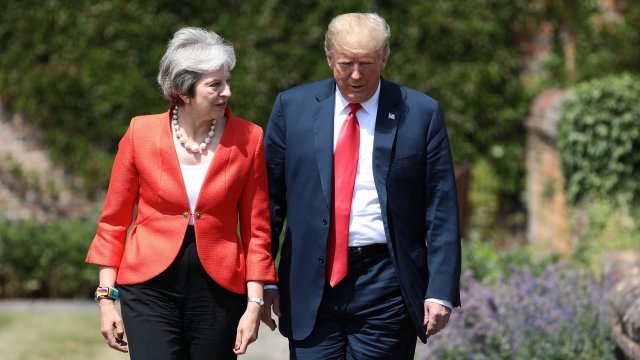 Prime Minister Theresa May walks with U.S. President Donald Trump.