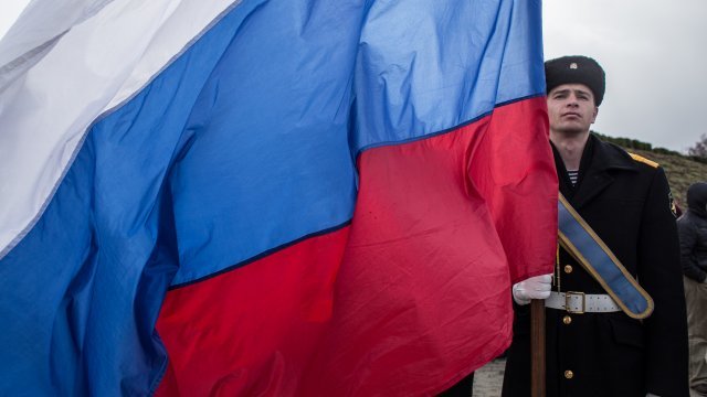 Navy sailor holds Russian flag