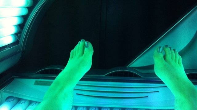 Person lays in a tanning bed