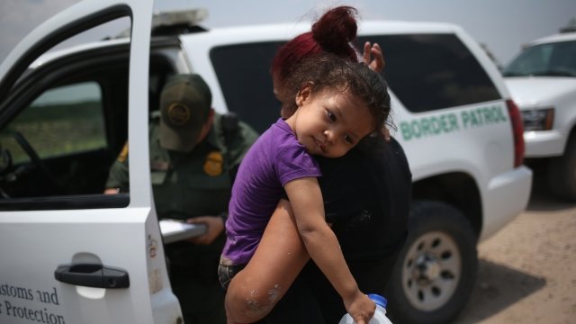 A mother and child from El Salvador await transport to a processing center for undocumented immigrants.