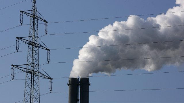 Exhaust plumes from the main chimneys of a power plant.