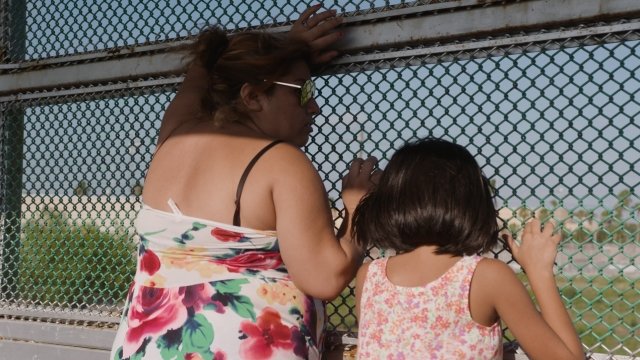 Rosa Irene Gomez Diaz and her daughter wait to request asylum at the U.S.-Mexico border.