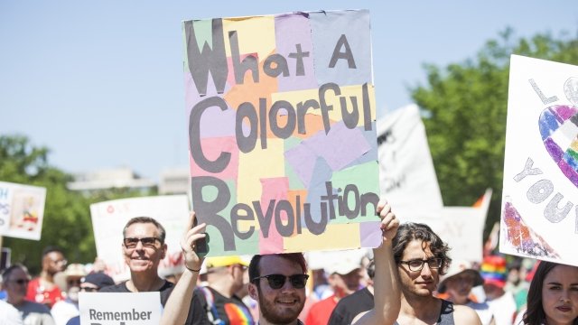 Demonstrators carry signs during Equality March for Unity and Peace