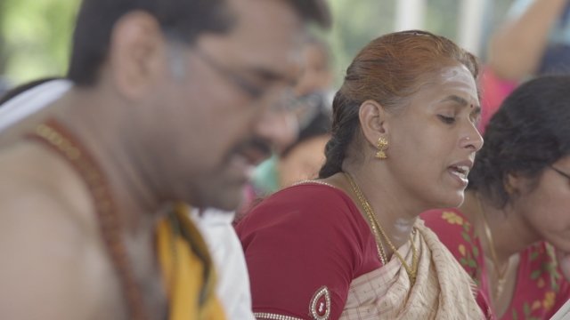 A woman chants during a Hindu celebration