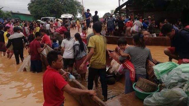 People on boats following Laos dam collapse