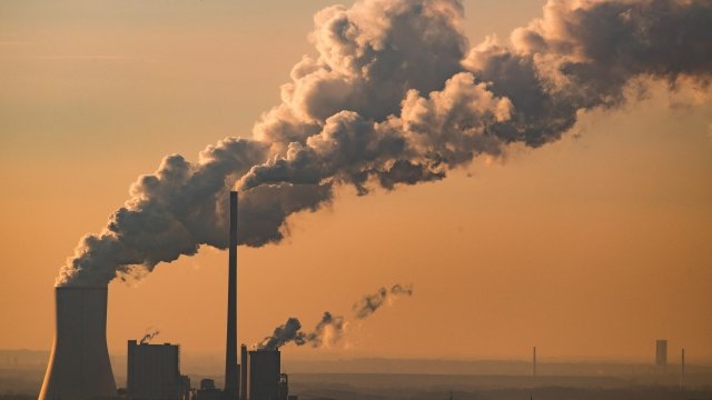Steam and exhaust pollution rises from a power plant