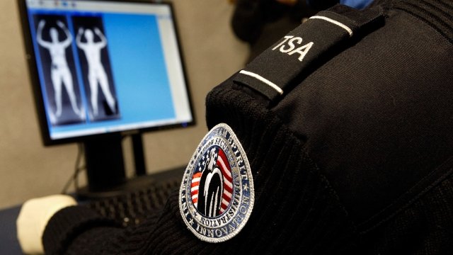 TSA agent screens passenger