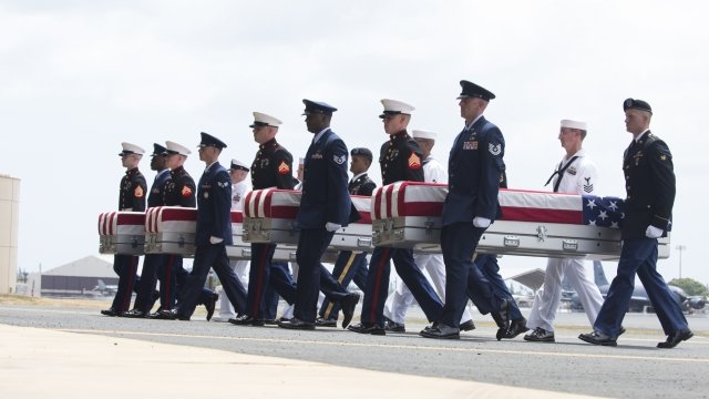 U.S. military carry the presumed remains of Korean War soldiers