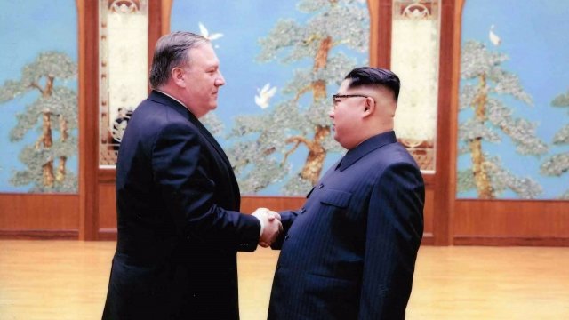 U.S. Secretary of State Mike Pompeo and North Korean leader Kim Jong-un shake hands