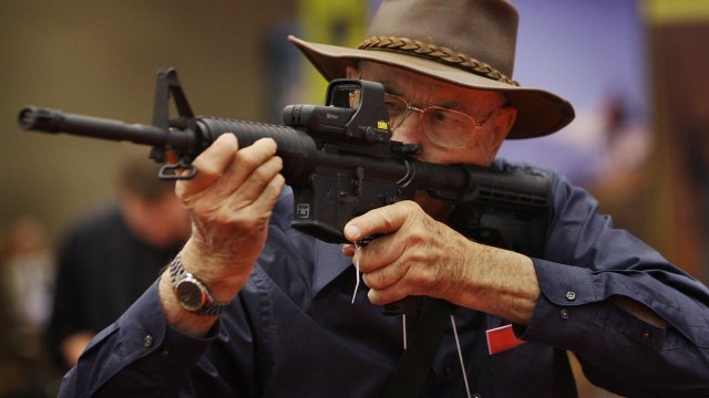 Man holds gun at NRA annual meeting