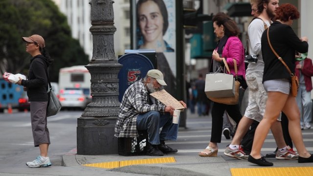 A homeless man asks for money in San Francisco.