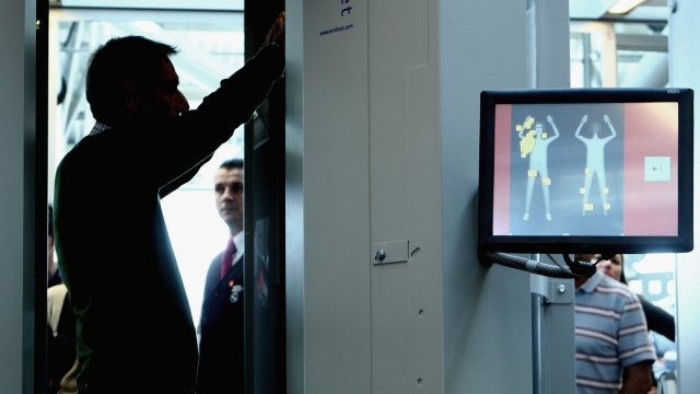 Man tests airport body scanner
