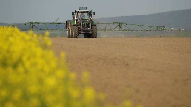 Farm equipment sprays pesticide
