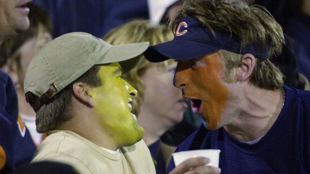 A Green Bay Packers fan and a Chicago Bears fan scream at each other.