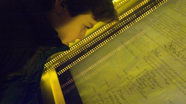 Ethan Kasnett, an 8th grade student at the Lab School in Washington, DC, views the original constitution after a ceremony.