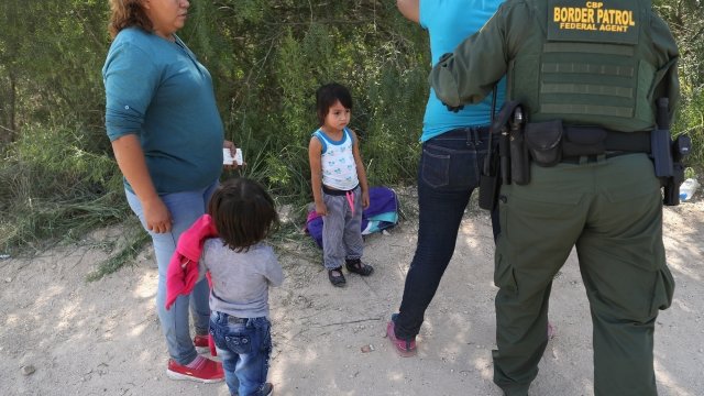 Border Patrol agent frisks a woman