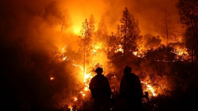 A picture of firefighters standing in front of the Mendocino Complex Fire.