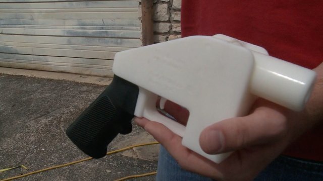 Man holding 3D-printed gun