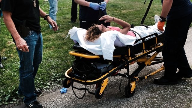 A woman is moved on a stretcher after an opioid overdose