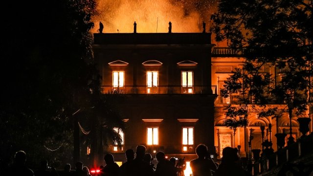 People watch a fire burn the National Museum of Brazil