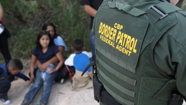 Border patrol agent and migrant family