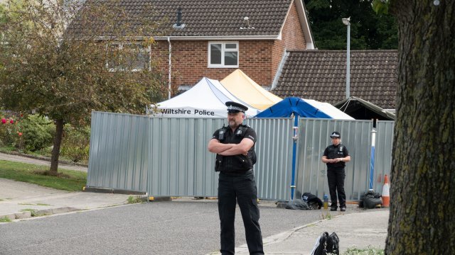U.K. police stand outside the former residence of Sergei Skripal