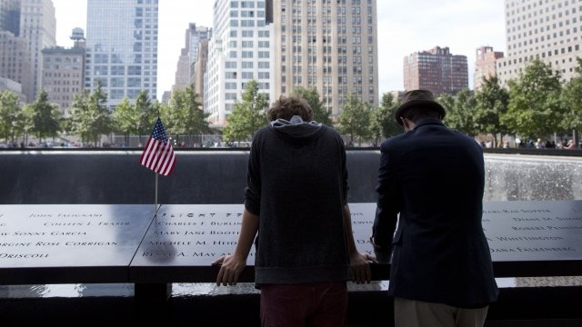 Two people read the names of victims at the 9/11 Memorial & Museum.