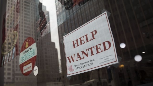 A 'help wanted' sign in the window of a business