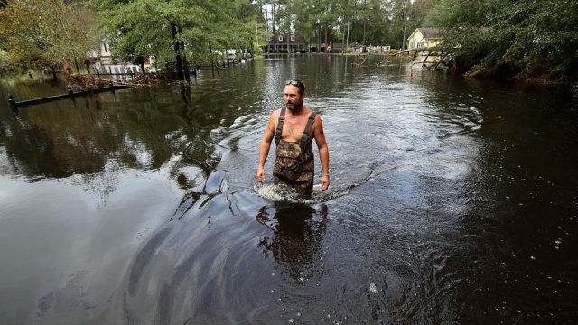 Scott Jones wades through about three feet of floodwater from Hurricane Florence.