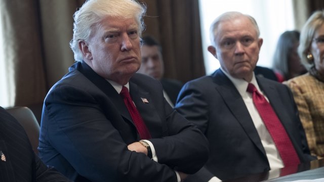 President Donald Trump and Attorney General Jeff Sessions sit next to each other at a meeting