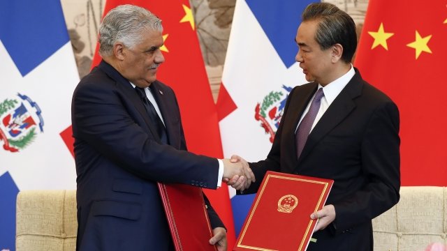 China's Foreign Minister Wang Yi shakes hands with Dominican Chancellor Miguel Vargas