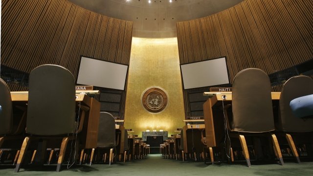 The United Nations logo on the back wall of the General Assembly Hall