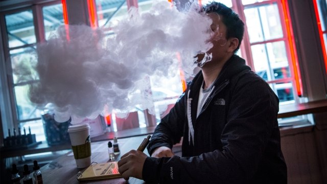 Person smokes an e-cigarette in New York City in 2014