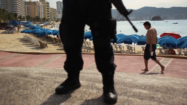 Mexican police officer stands by Acapulco beach