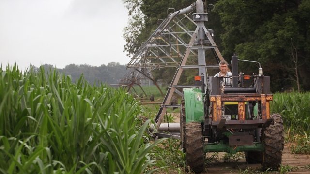 Jud Vaught moves an irrigation system in his cornfield near Whiteland, Indiana. He is a 6th generation farmer.