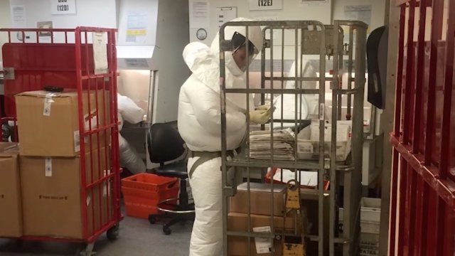Officials in protective gear securing the Pentagon's remote mail facility