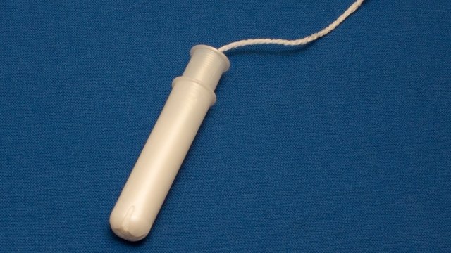 Tampon with plastic applicator
