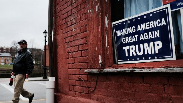 A Donald Trump sign hangs in the window in the town of Waynesburg near the West Virginia border