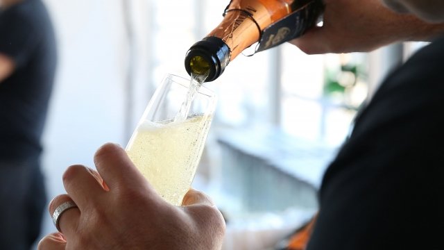 Bartender pours a glass of prosecco during the Food Network's New York City Food and Wine Festival in 2014