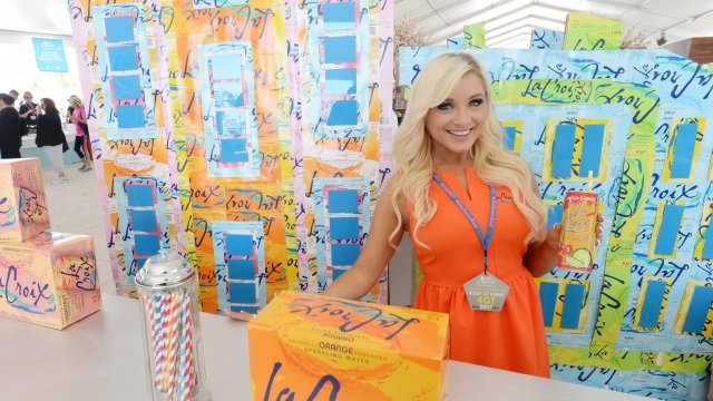 Woman surrounded by boxes of LaCroix