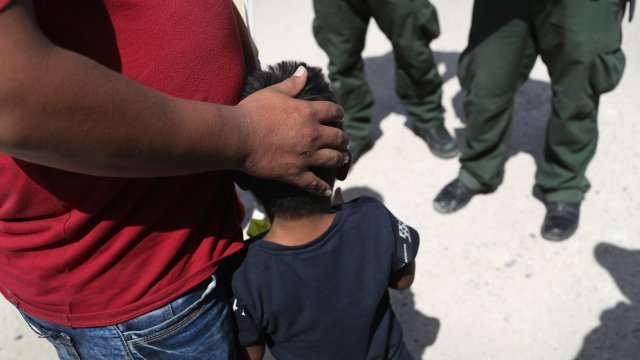 U.S. Border Patrol agents take a father and son from Honduras into custody near the U.S.-Mexico border.