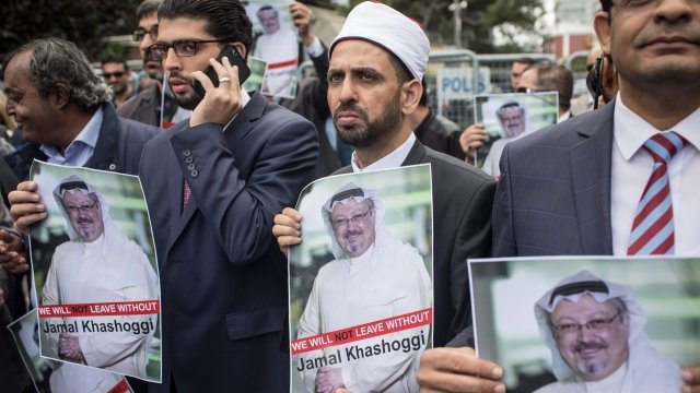 People hold pictures of Jamal Khashoggi